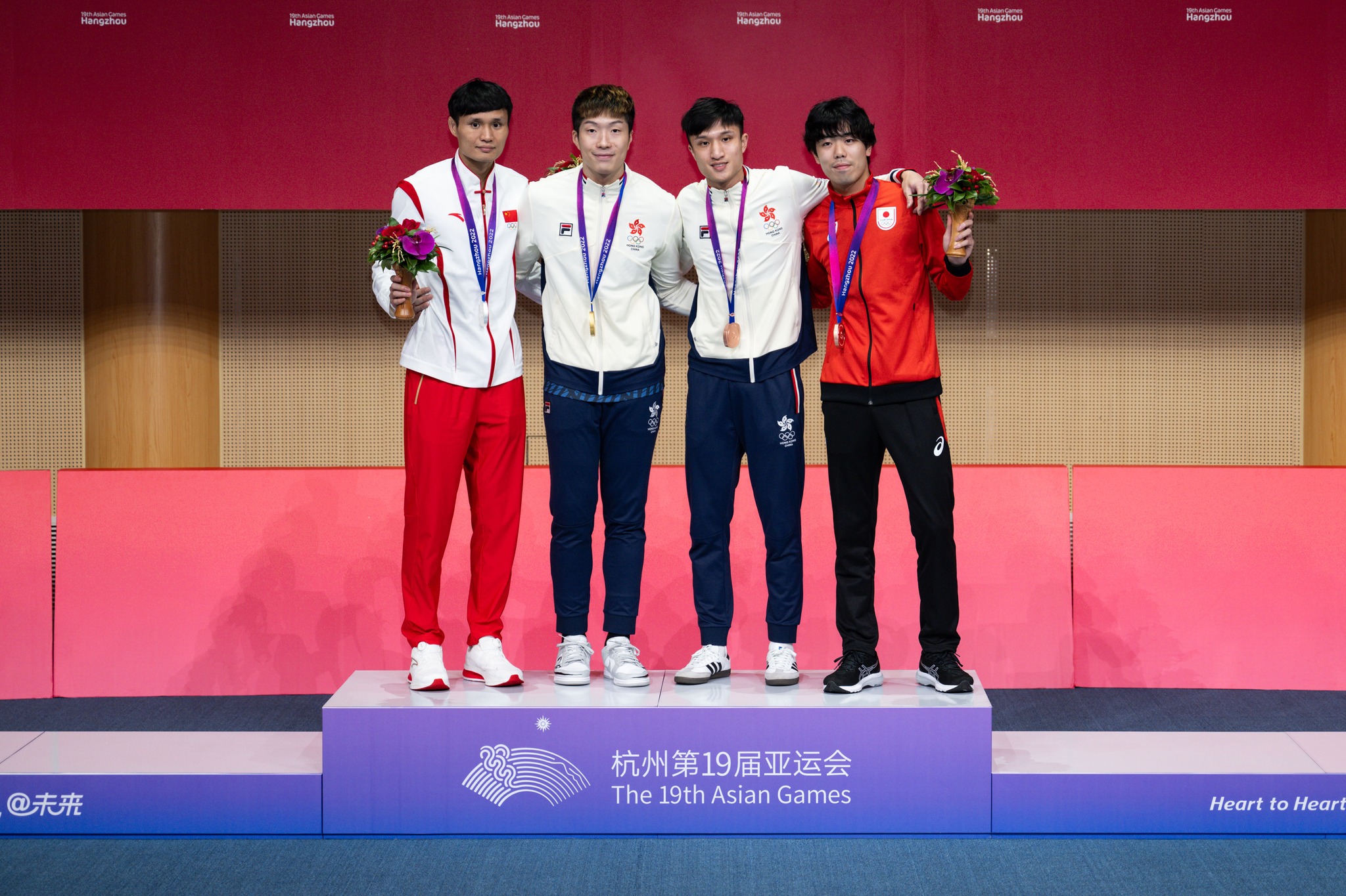 Fencer Cheung Ka-long (2nd L) wins a gold medal in Men's Foil Individual, while his teammate Ryan Choi (2nd R) bags a bronze medal. (2023)