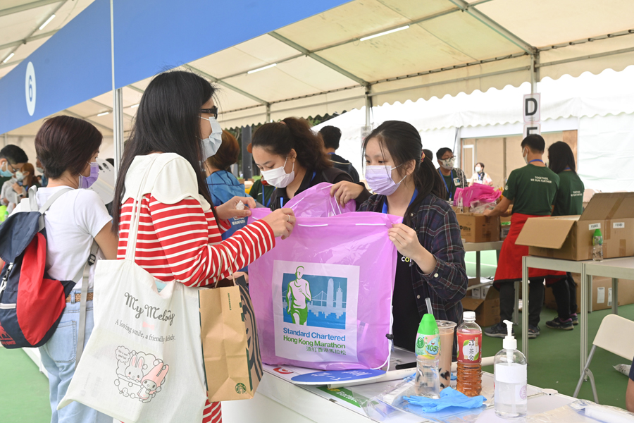 Participants of Hong Kong Marathon collect runner's pack at the Victoria Park.