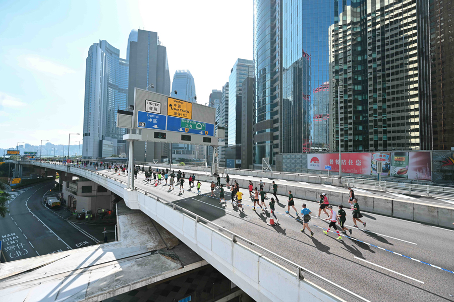 Runners compete in the shadows of Hong Kong's towering cityscape.