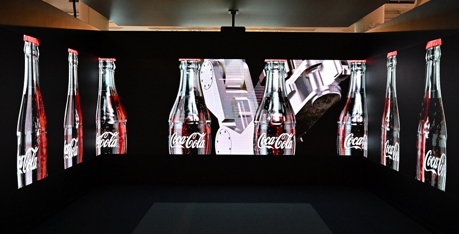 An interactive exhibit walks visitors through the bottling of a classic soft drink.